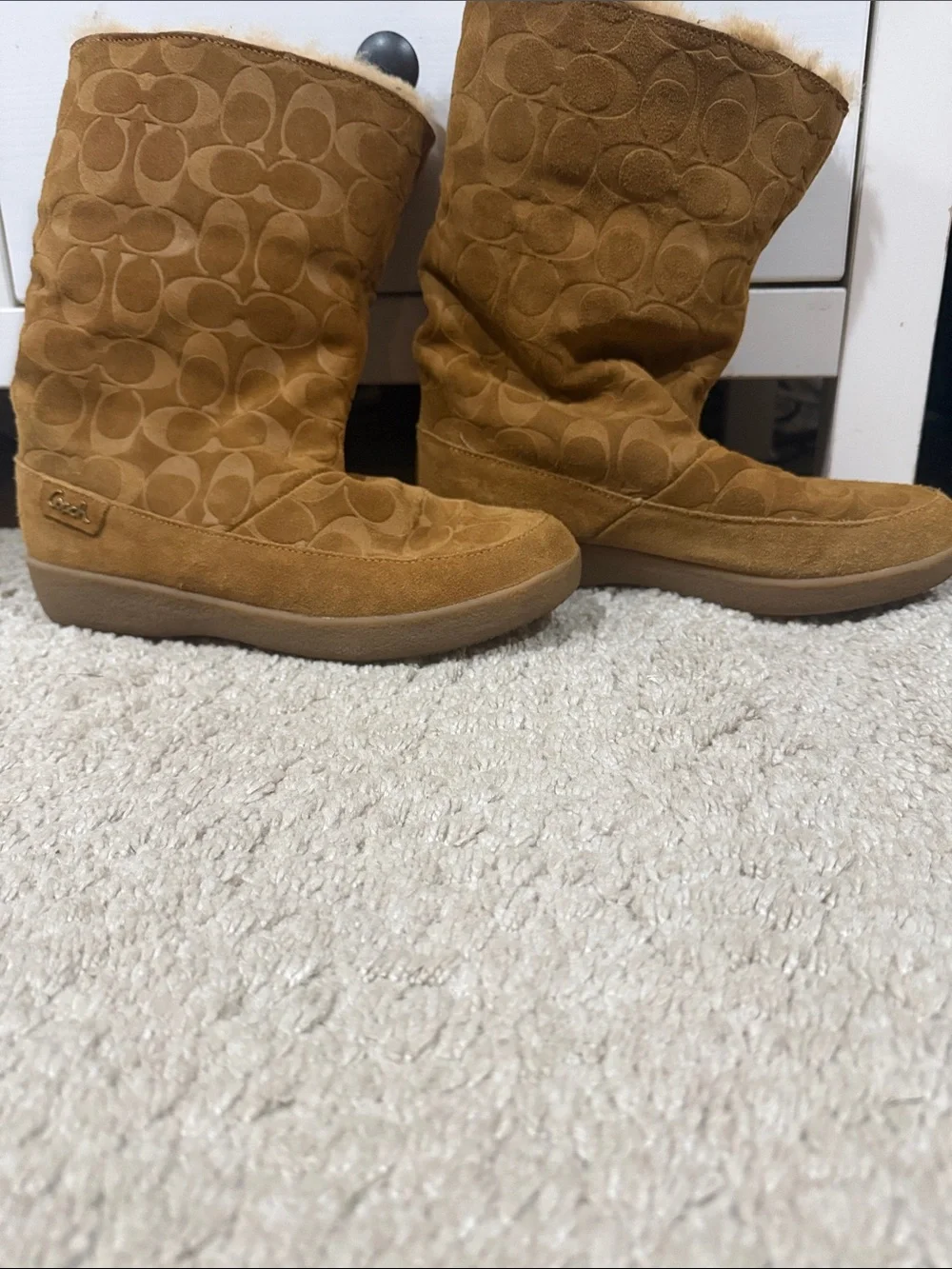 Coach suede boot with embossed signature pattern. Soft tan suede upper. Platform